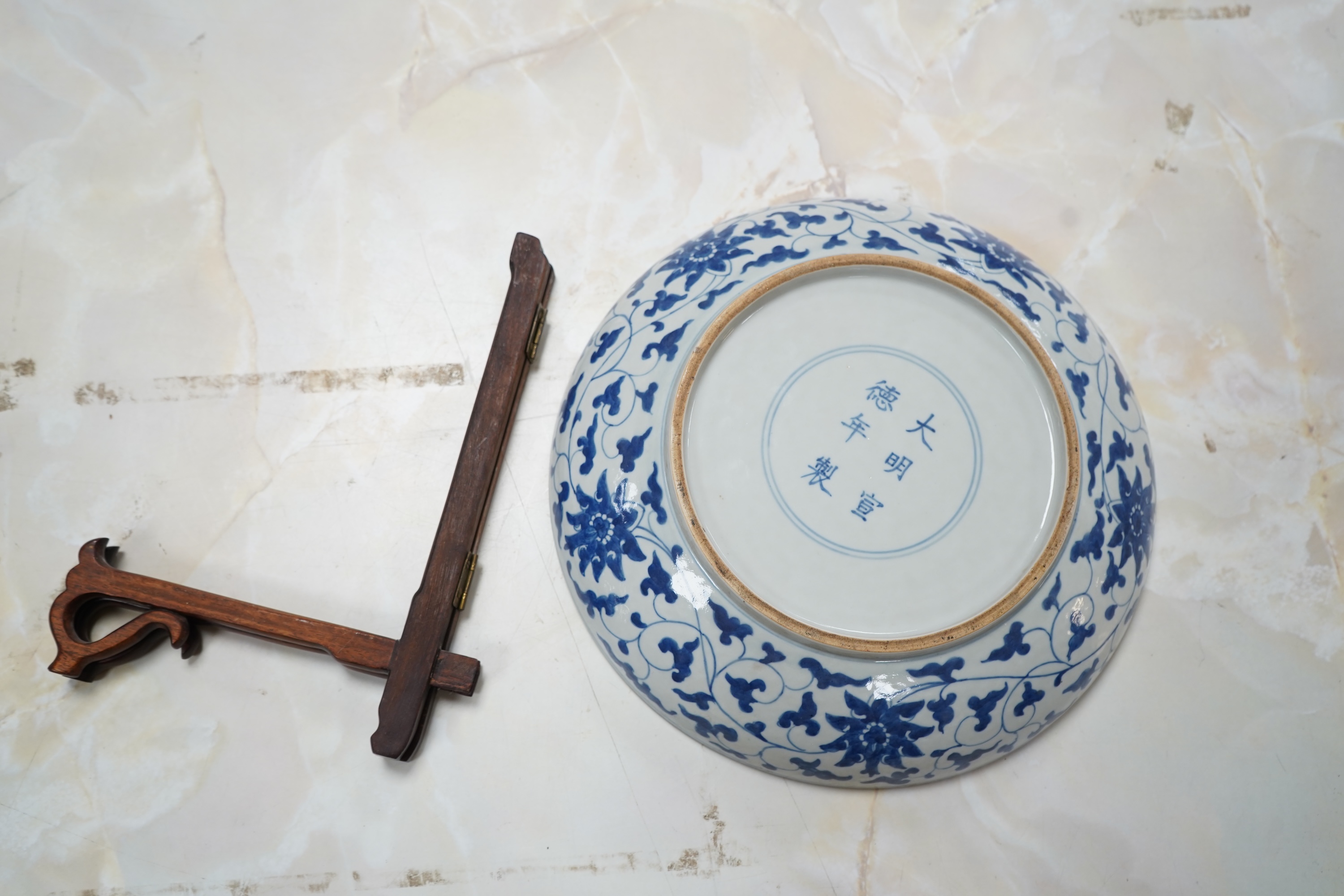 A Chinese black and white 'dragon' dish Xuande mark, 20th century, 27cm diameter